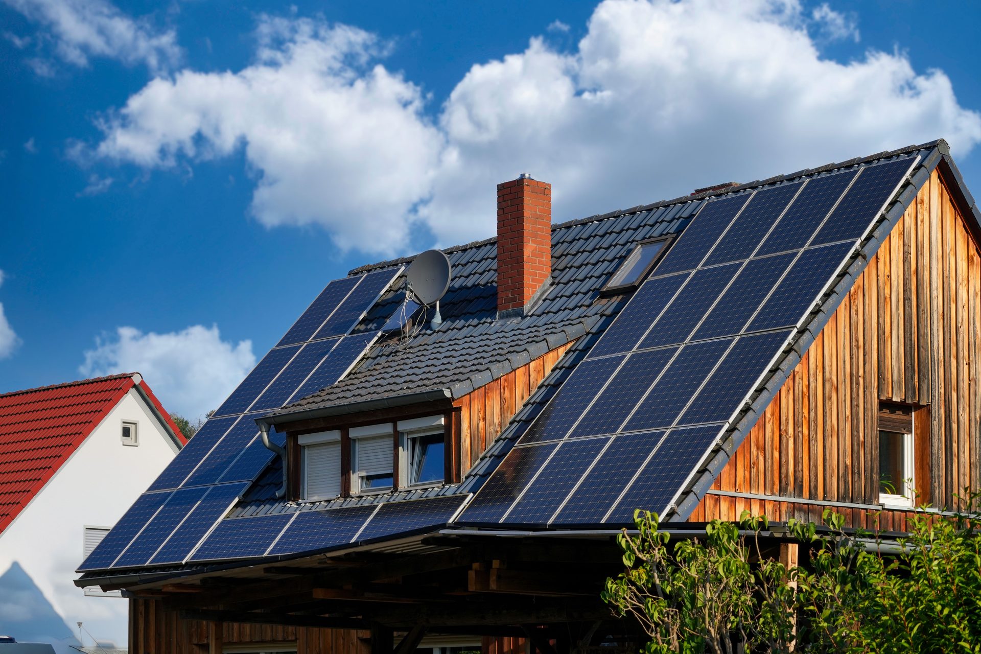 Wood-clad home with a large rooftop solar array