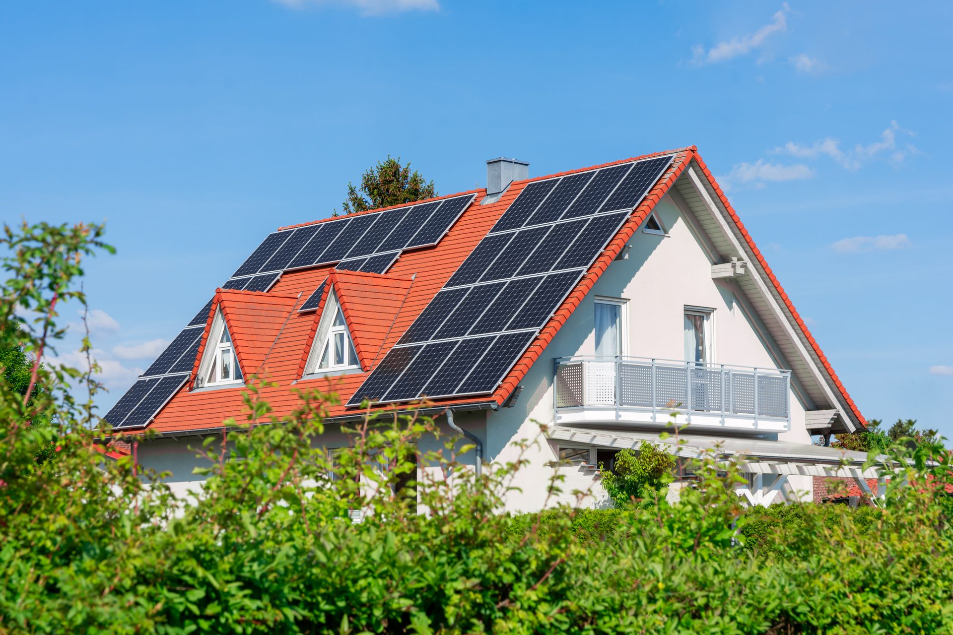 Suburban home with solar panels on a red roof